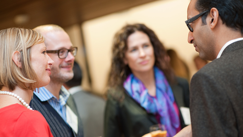 Group of faculty socializing.