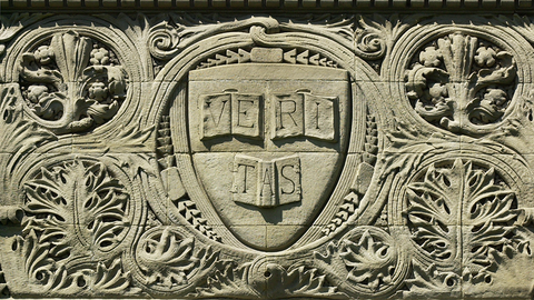 Harvard's Veritas shield carved in stone.