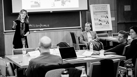 Faculty member teaching a group of faculty members in a classroom.