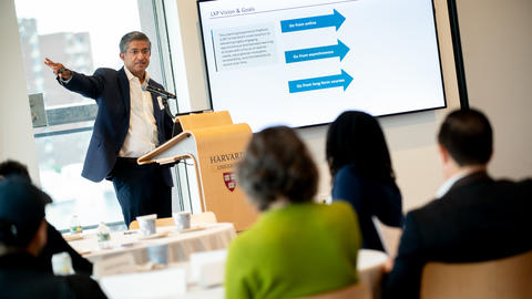 Vice Provost Bharat Anand presenting to a group of faculty.