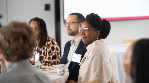 A group of faculty members seated around a table.