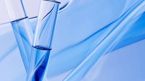 Two test tubes against an abstract blue background.