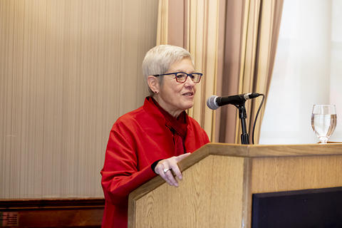 Senior Vice Provost Judy Singer making welcome remarks at the podium.