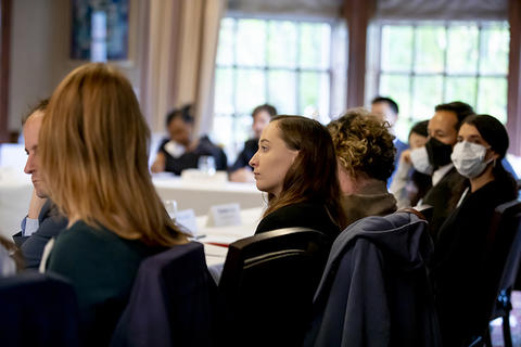 New faculty attendees listening to welcome remarks.