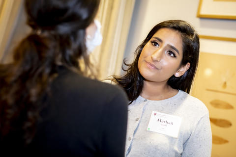 Two new faculty members in conversation at the reception.