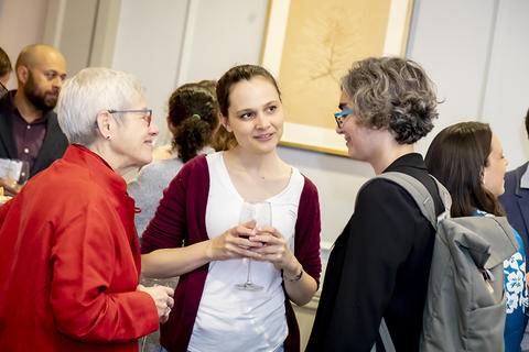 Two new faculty members in conversation with Senior Vice Provost Judy Singer during the reception.