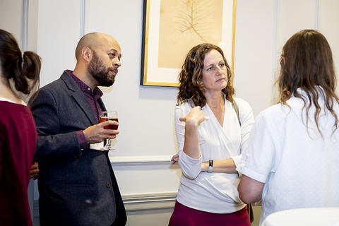 Reception attendees in conversation.