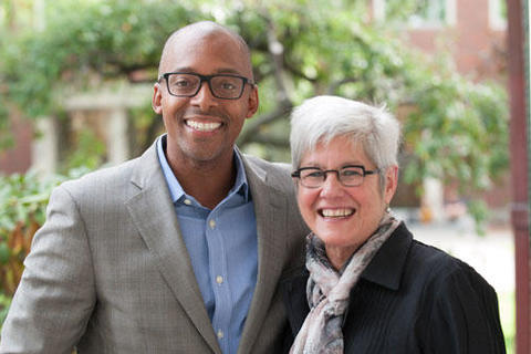 A new faculty member stands with Senior Vice Provost Judith Singer, both smiling for the camera.