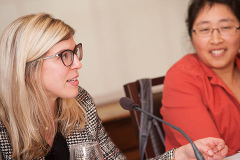 Closeup of two panelists, both women, speaking to the group.