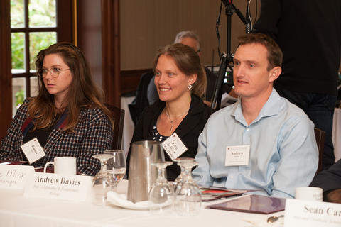 Three seated attendees listening to the panel.