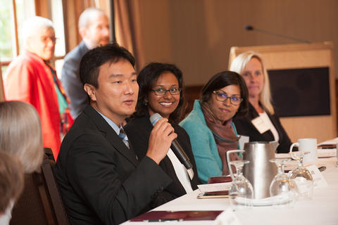 A new faculty member speaks during the Q&A.