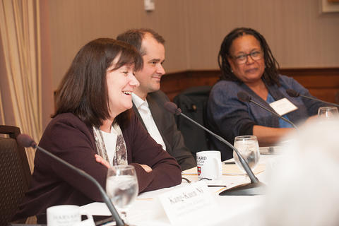 The NFI panelists address the audience, smiling.