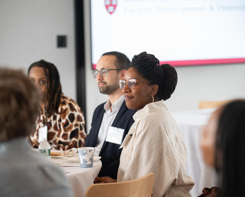 A group of faculty members seated around a table.