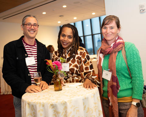 Three faculty members at a reception.